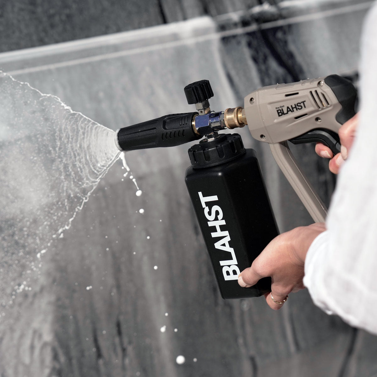 BLAHST foam cannon spraying soap onto a dark surface