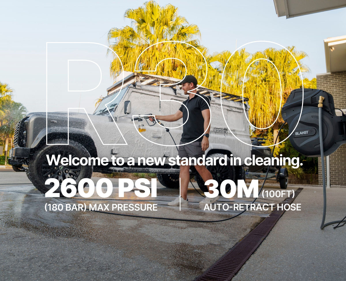 BLAHST R30 pressure washer cleaning a foam-covered 4x4 in a driveway